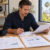 Business owner reviewing invoices, an inventory report and property financing documents